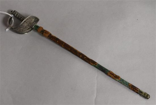 An early 20th century novelty sterling silver letter opener, modelled as a sabre in leather scabbard, 23cm.